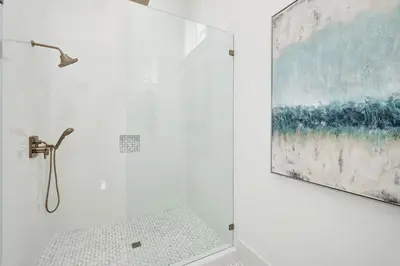 a bathroom with a shower with a painting on the wall at Marisol 30A in Inlet Beach