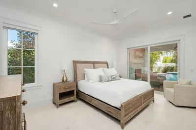 a white bedroom with a bed and a window at Marisol 30A in Inlet Beach