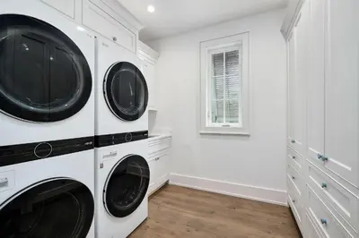 two washers and dryers in a white laundry room at Sea Turtle Retreat in Seagrove Beach