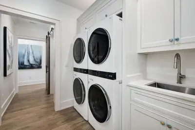 a white kitchen with four washer and dryer at Sea Turtle Retreat in Seagrove Beach
