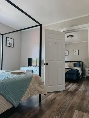 a bedroom with a bed and a door to a bedroom at Coastal Farmhouse - Pet Friendly and Quiet Location in Southport
