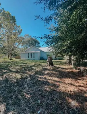 a white house with a tree in the yard at Coastal Farmhouse - Pet Friendly and Quiet Location in Southport