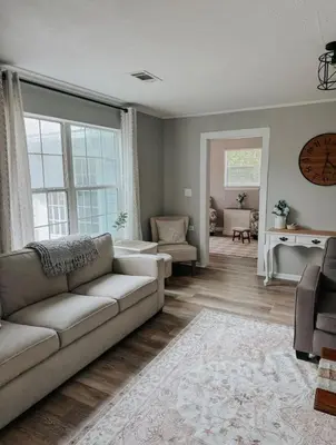 a living room with a couch and a window at Coastal Farmhouse - Pet Friendly and Quiet Location in Southport