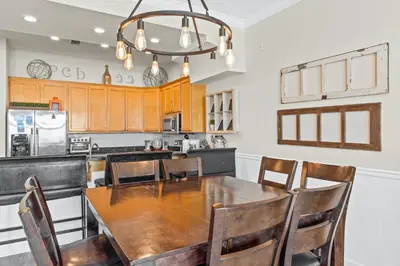 a kitchen with a wooden table and chairs at Southern Exposure Beach Home in Panama City Beach