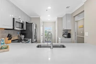 a kitchen with white cabinets and a sink at High Pointe Resort Unit 44E in Inlet Beach