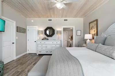 a bedroom with a white bed and a ceiling fan at High Pointe Resort Unit 44E in Inlet Beach