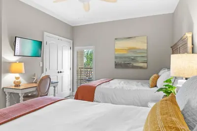 a bedroom with two beds and a desk with a computer at High Pointe Resort Unit 44E in Inlet Beach