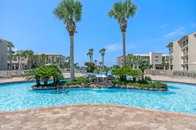 a large swimming pool with palm trees in a resort at High Pointe Resort Unit 44E in Inlet Beach