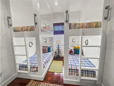 a room with two bunk beds in a house at 116 Surfer Ln l Resort Style Community Pool l Walk to Rosemary Beach in Rosemary Beach