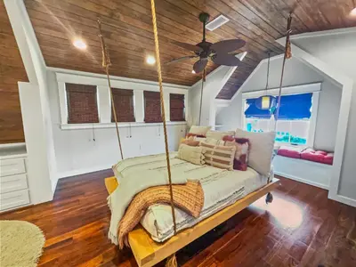 a bedroom with a swinging bed with a ceiling fan at 116 Surfer Ln l Resort Style Community Pool l Walk to Rosemary Beach in Rosemary Beach