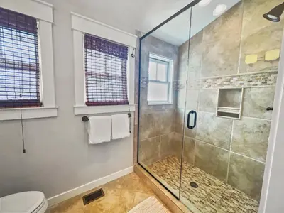 a bathroom with a shower and a toilet at 116 Surfer Ln l Resort Style Community Pool l Walk to Rosemary Beach in Rosemary Beach