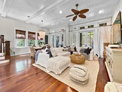 a living room with white furniture and a ceiling fan at 116 Surfer Ln l Resort Style Community Pool l Walk to Rosemary Beach in Rosemary Beach