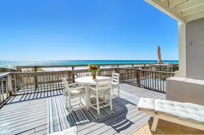 a balcony with a table and chairs and the beach at Book Me Baby! You are in Luck! I Am Gulf Front! in Santa Rosa Beach