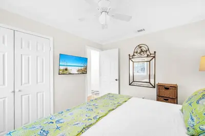 a white bedroom with a bed and a ceiling fan at Book Me Baby! You are in Luck! I Am Gulf Front! in Santa Rosa Beach