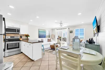a kitchen and living room with a table and a dining room at Book Me Baby! You are in Luck! I Am Gulf Front! in Santa Rosa Beach