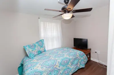 a bedroom with a bed and a ceiling fan at 16 Chateau in Panama City Beach