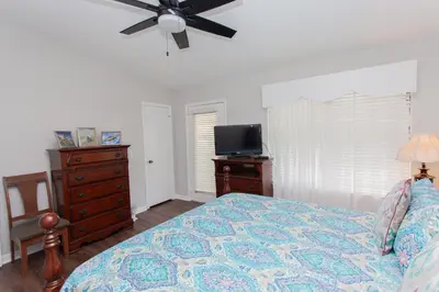 a bedroom with a bed and a ceiling fan at 16 Chateau in Panama City Beach