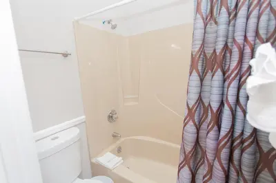 a bathroom with a shower curtain and a toilet at 16 Chateau in Panama City Beach