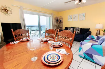 a living room with a table and a couch at Summit 903 in Panama City Beach