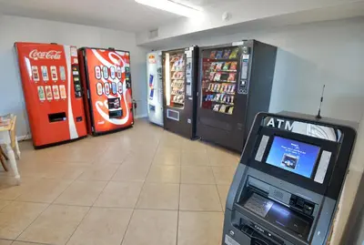 a video game machine in a room with two soda machines at Summit 903 in Panama City Beach