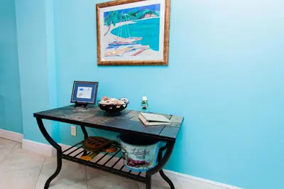 a desk in a room with a picture on the wall at Regency 1023 in Panama City Beach