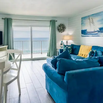 a blue couch in a living room with a view of the ocean at Summit 811 in Panama City Beach