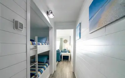 a room with two bunk beds and a desk at Summit 811 in Panama City Beach