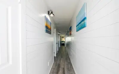 a hallway in a house with white walls at Summit 811 in Panama City Beach