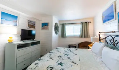 a bedroom with a bed and a flat screen tv at Summit 811 in Panama City Beach