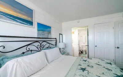 a bedroom with a white bed with a black frame at Summit 811 in Panama City Beach