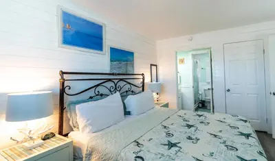 a bedroom with a bed with a blue and white comforter at Summit 811 in Panama City Beach