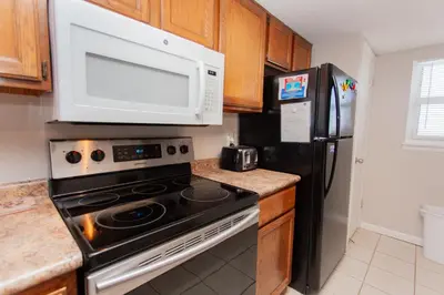 a kitchen with a stove and a microwave at Moonspinner 808B in Panama City Beach