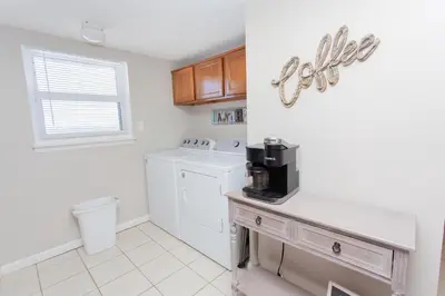 a kitchen with a washer and dryer on a counter at Moonspinner 808B in Panama City Beach