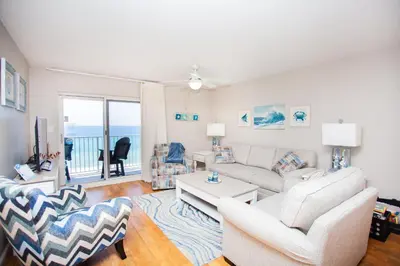 a living room with a couch and a table at Moonspinner 808B in Panama City Beach