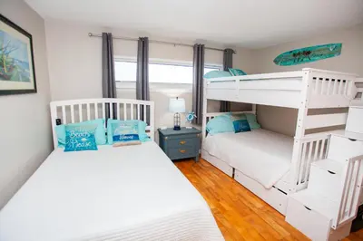 two beds in a room with two bunk beds at Moonspinner 808B in Panama City Beach