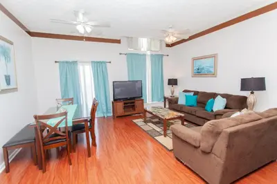 a living room with a couch and a table at Palms A4 Main in Panama City Beach