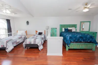 a bedroom with two beds and a ceiling fan at Palms A4 Main in Panama City Beach