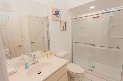 a bathroom with a toilet and a sink and a shower at Palms A4 Main in Panama City Beach