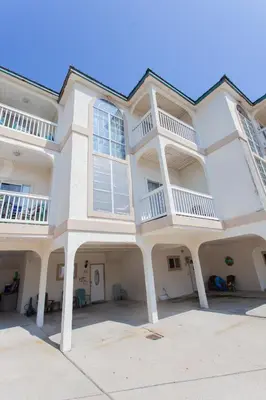 a large white building with balconies on top of it at Palms A4 Main in Panama City Beach