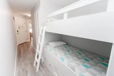 a bedroom with a bunk bed and a ladder at Horizon South 58-203 in Panama City Beach