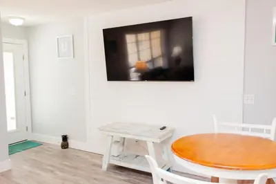 a room with a table and a tv on the wall at Horizon South 58-203 in Panama City Beach