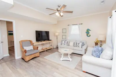 a living room with a couch and a tv at 125 E Lakeshore DR in Panama City Beach