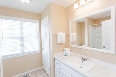 a bathroom with a sink and a mirror at 125 E Lakeshore DR in Panama City Beach