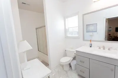 a white bathroom with a toilet and a sink at 125 E Lakeshore DR in Panama City Beach
