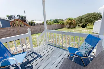 two chairs on a porch with a view of a yard at 125 E Lakeshore DR in Panama City Beach