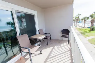 a balcony with a table and chairs on a balcony at Summit 203 in Panama City Beach