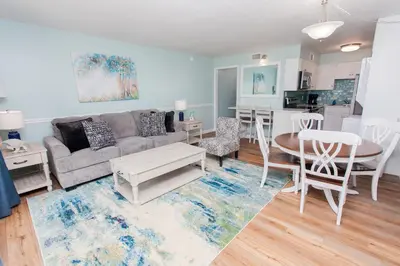 a living room with a couch and a table at Summit 203 in Panama City Beach