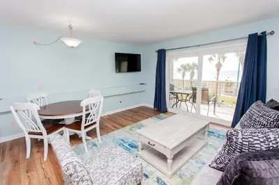 a living room with a table and a couch at Summit 203 in Panama City Beach