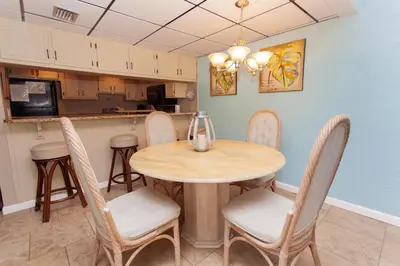a kitchen and dining room with a table and chairs at Sugar Beach E2 in Panama City Beach