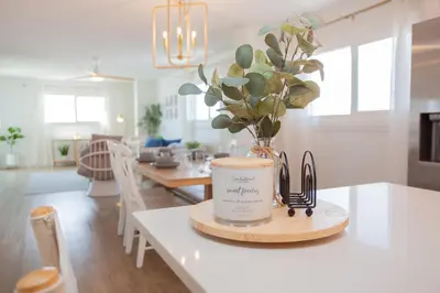 a kitchen counter with a coffee mug and a vase of flowers at Regency 501 in Panama City Beach